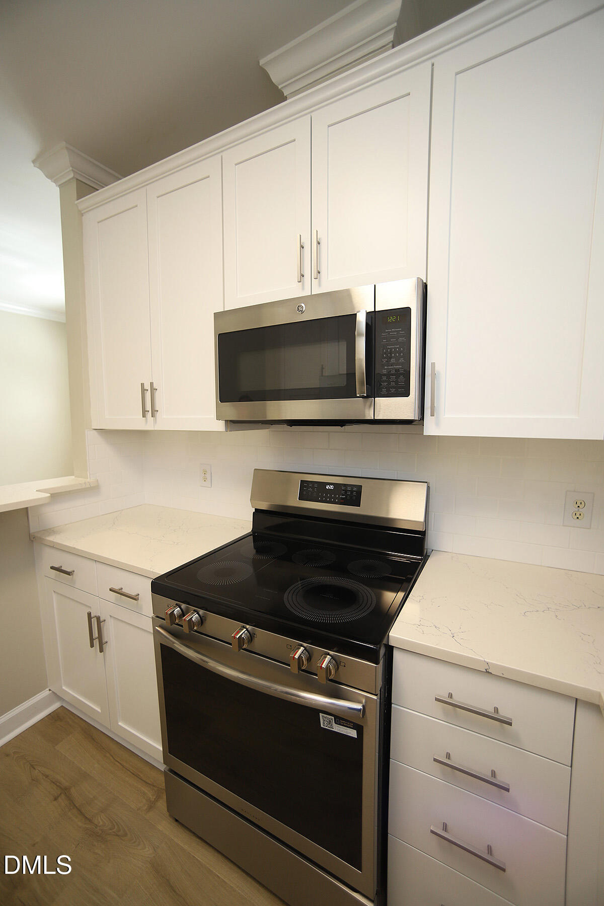 100 Northbrook Drive, Unit 207 Raleigh, NC 27609 - Photo 17 of 39 a kitchen with a stove and a microwave