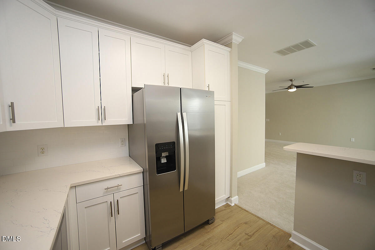 100 Northbrook Drive, Unit 207 Raleigh, NC 27609 - Photo 18 of 39 a kitchen with a refrigerator sink and cabinets