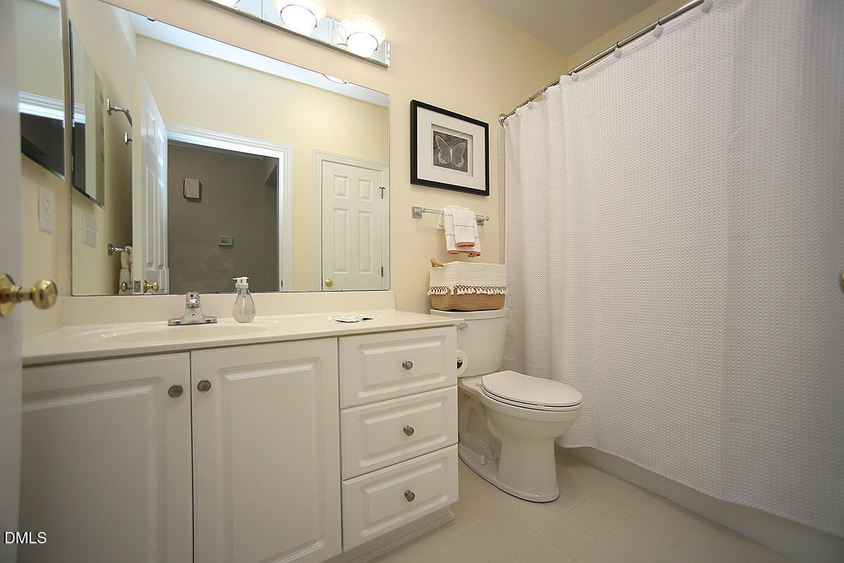 100 Northbrook Drive, Unit 207 Raleigh, NC 27609 - Photo 30 of 39 a bathroom with a toilet sink and mirror