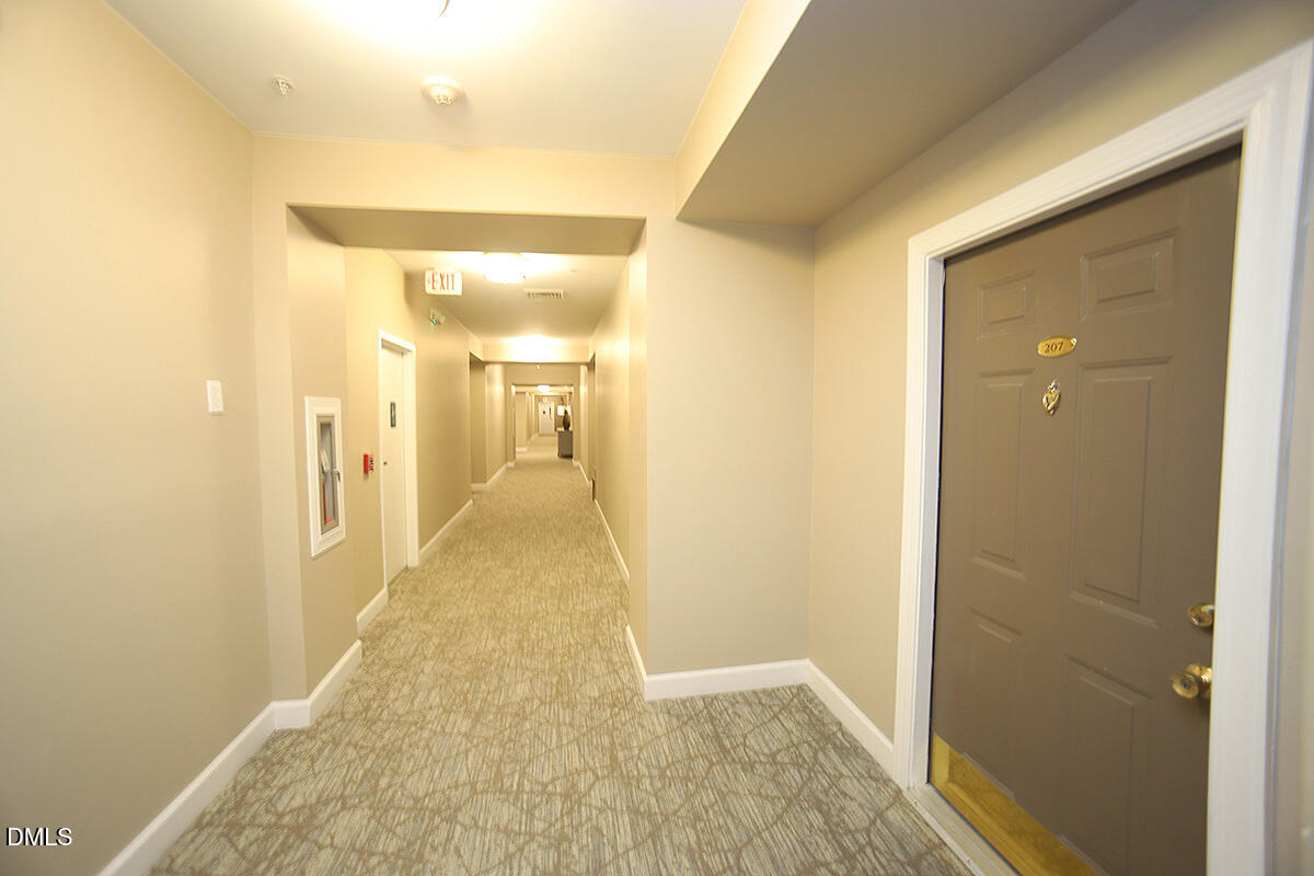 100 Northbrook Drive, Unit 207 Raleigh, NC 27609 - Photo 8 of 39 a view of a hallway with wooden floor