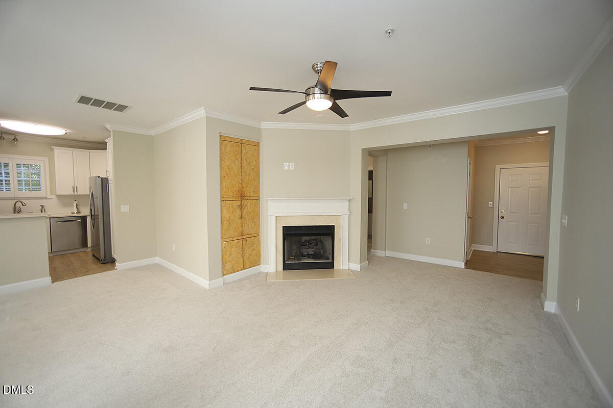 100 Northbrook Drive, Unit 207 Raleigh, NC 27609 - Photo 10 of 39 a view of a livingroom with a fireplace and a ceiling fan