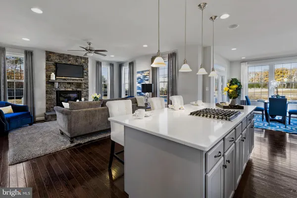 a kitchen with a sink a counter top space a large window and stainless steel appliances