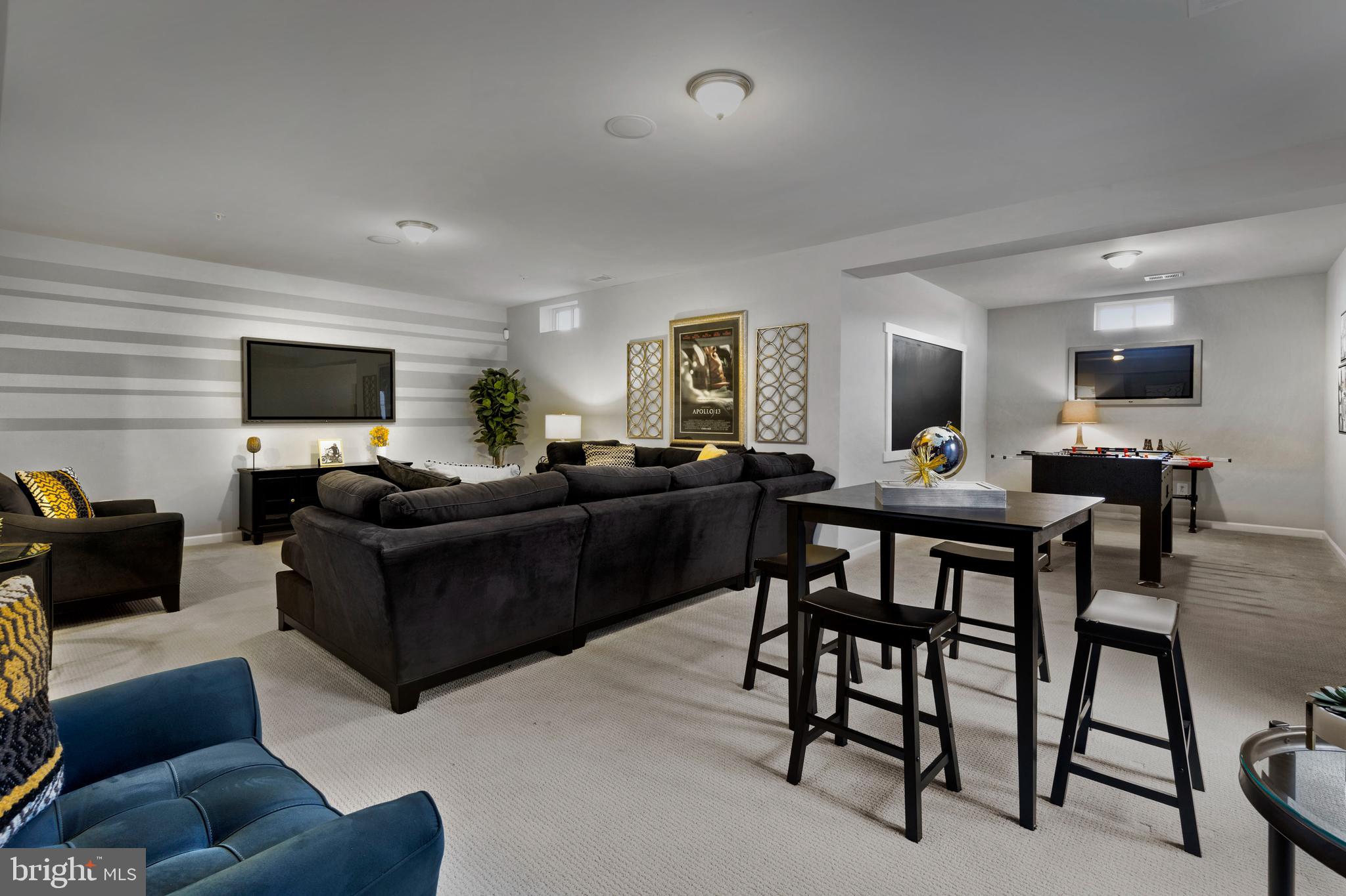 Tbb Tbb Marquee Farm Road, Unit NEWBURY Charles Town, WV 25414 - Photo 5 of 25 a living room with furniture and a flat screen tv