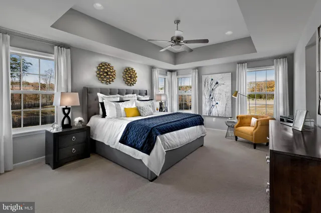 a spacious bedroom with a bed and glass window