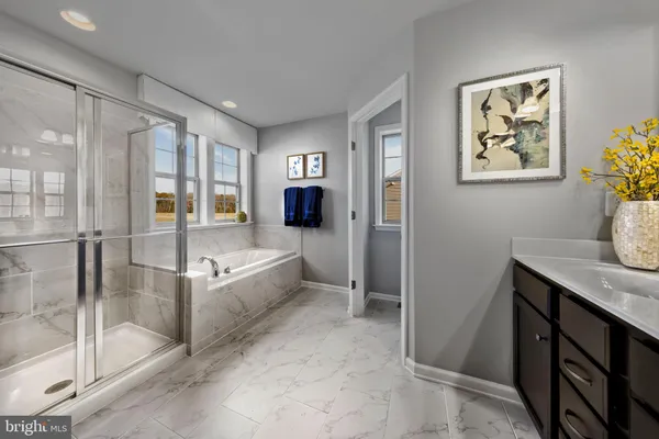 a spacious bathroom with a tub and shower