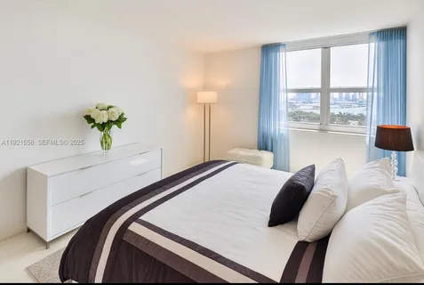 a bedroom with a bed and a lamp