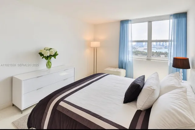 a bedroom with a bed and a lamp