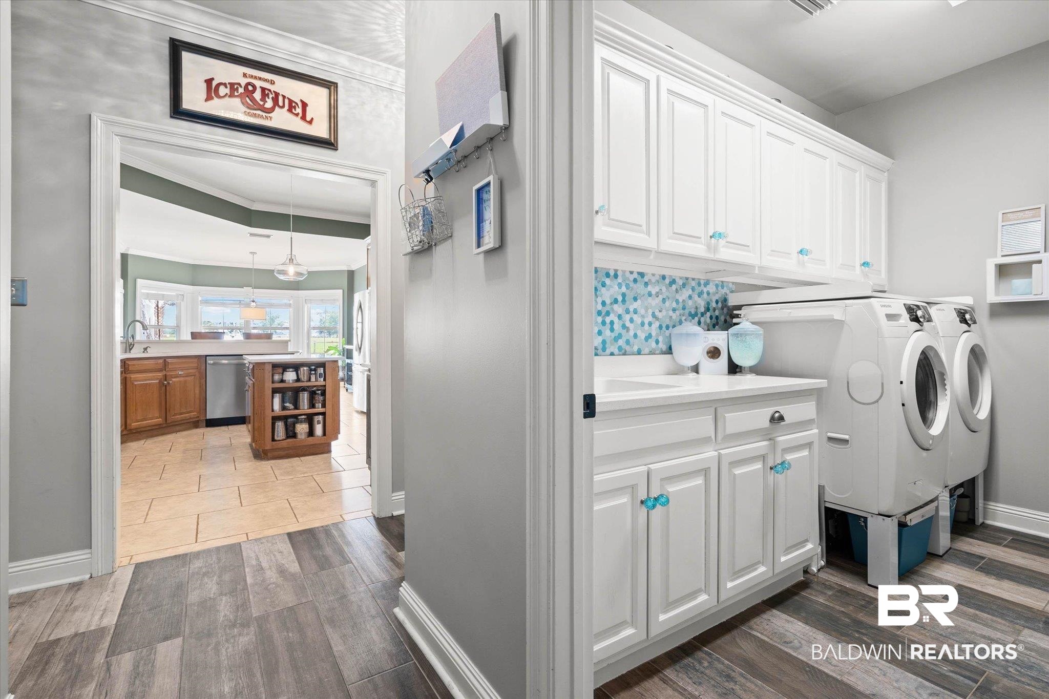 24908 Bosbyshell Avenue Daphne, AL 36526 - Photo 12 of 49 Laundry area featuring white cabinetry, a built-in sink, and a blue mosaic tile backsplash