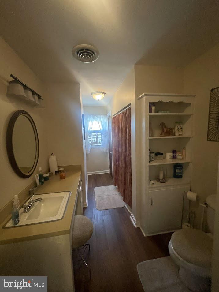 202 Gumboro Road Selbyville, DE 19975 - Photo 11 of 22 a bathroom with a sink a toilet and a mirror