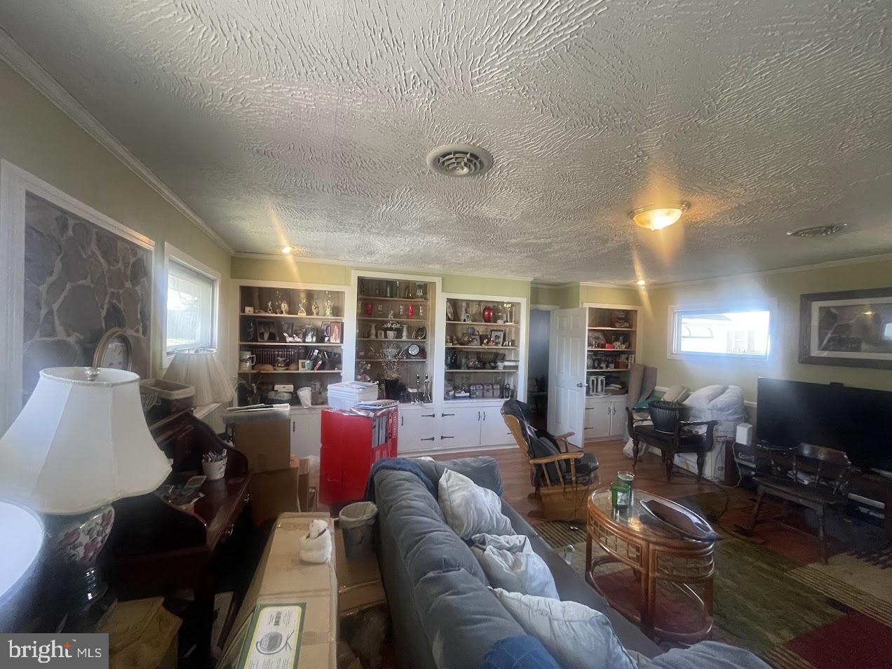 202 Gumboro Road Selbyville, DE 19975 - Photo 14 of 22 a living room with furniture and a flat screen tv