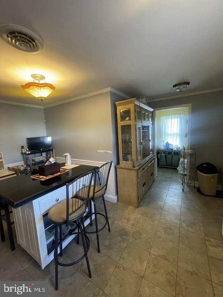 202 Gumboro Road Selbyville, DE 19975 - Photo 5 of 22 a kitchen with refrigerator and chairs