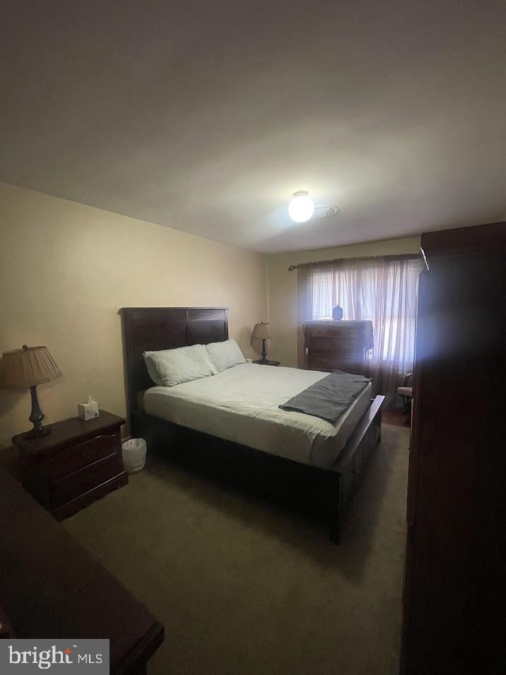 202 Gumboro Road Selbyville, DE 19975 - Photo 10 of 22 a bedroom with a bed and a night stand on dresser