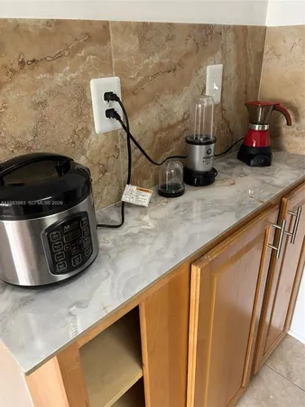 a bathroom with a granite countertop toilet and a sink
