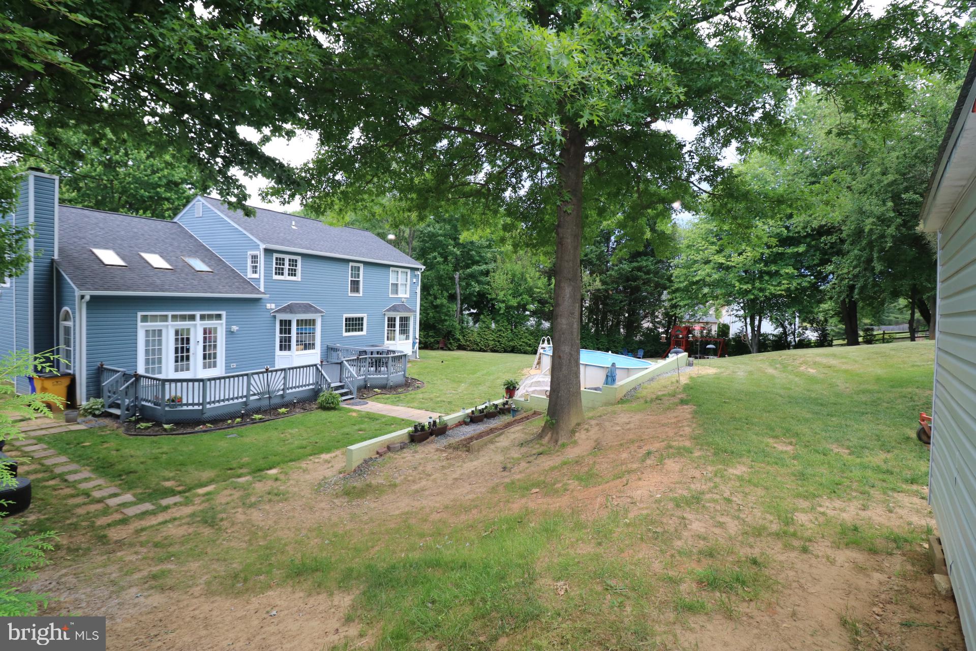 11901 Rustic Farm Court Germantown, MD 20874 - Photo 107 of 134 Charming blue home with lush greenery.