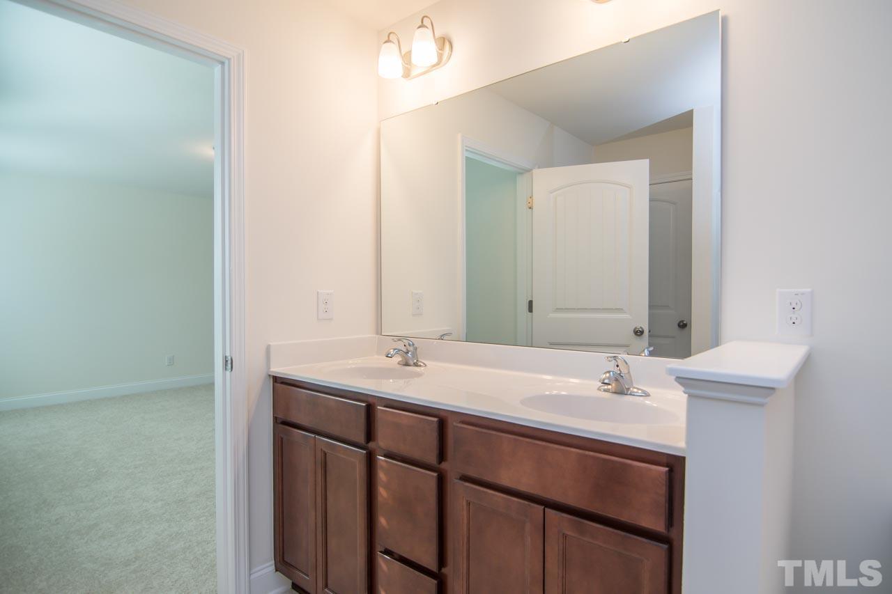4531 Lord Mario Court Raleigh, NC 27610 - Photo 13 of 27 a bathroom with a sink and a mirror