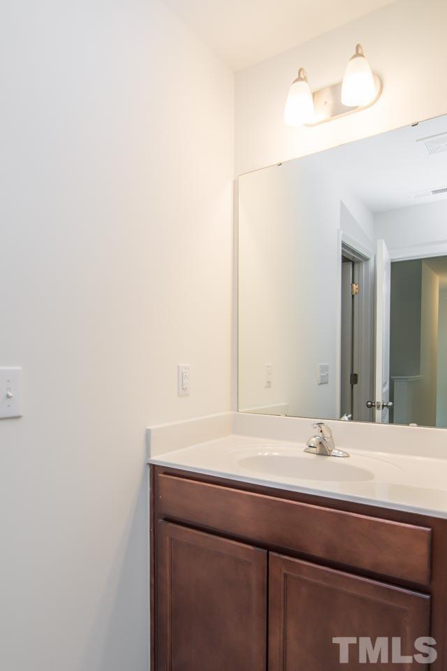4531 Lord Mario Court Raleigh, NC 27610 - Photo 20 of 27 a bathroom with a sink and a mirror