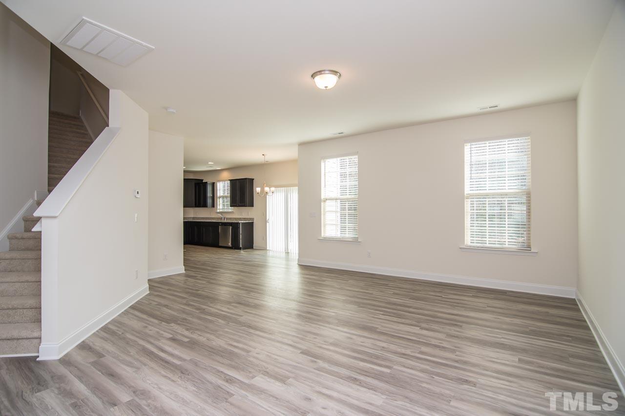 4531 Lord Mario Court Raleigh, NC 27610 - Photo 3 of 27 an empty room with wooden floor and windows