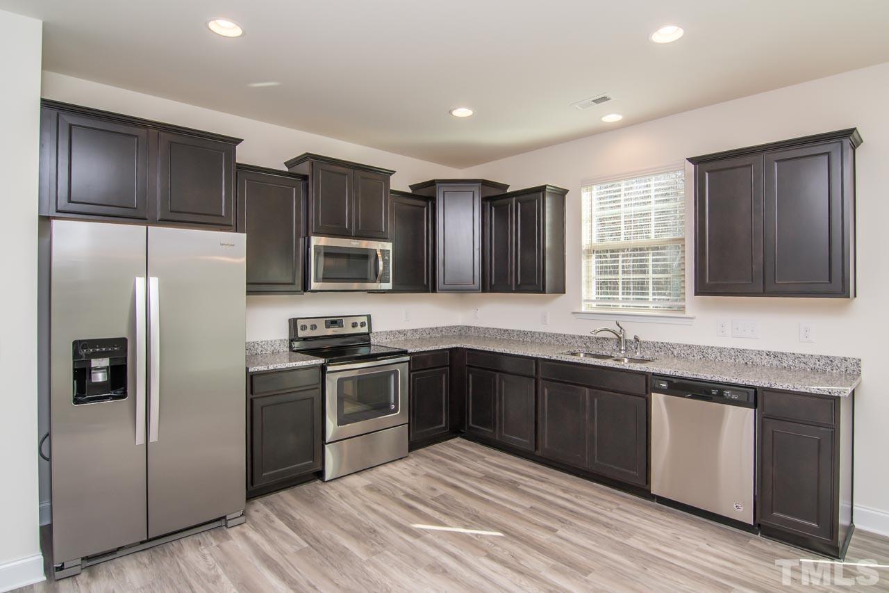 4531 Lord Mario Court Raleigh, NC 27610 - Photo 4 of 27 a kitchen with granite countertop stainless steel appliances cabinets a sink and a window