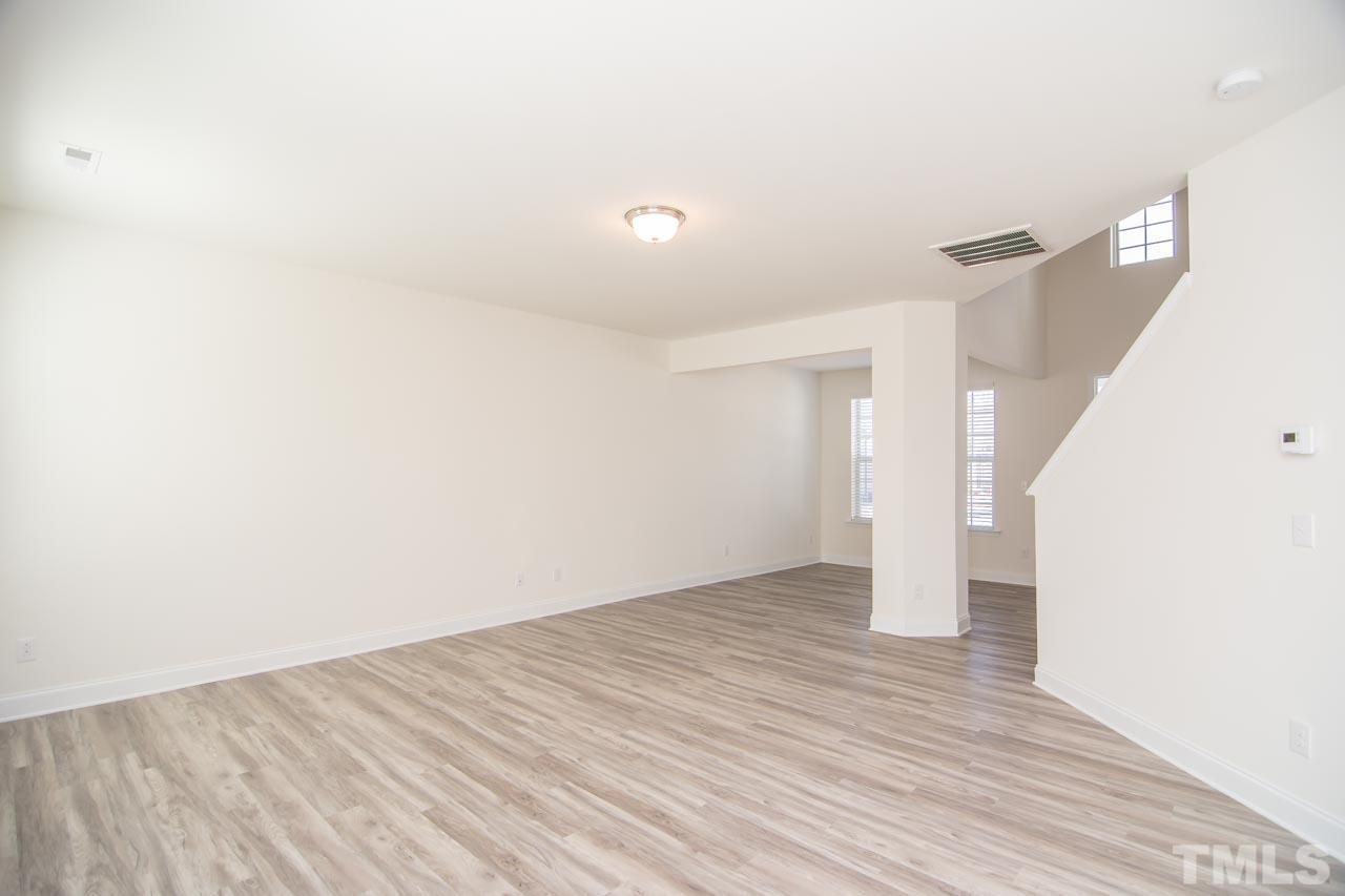 4531 Lord Mario Court Raleigh, NC 27610 - Photo 8 of 27 a view of an empty room with wooden floor and a window