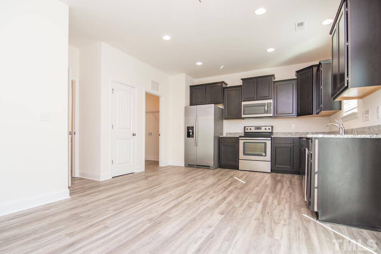 4531 Lord Mario Court Raleigh, NC 27610 - Photo 10 of 27 a kitchen with stainless steel appliances a refrigerator and a oven