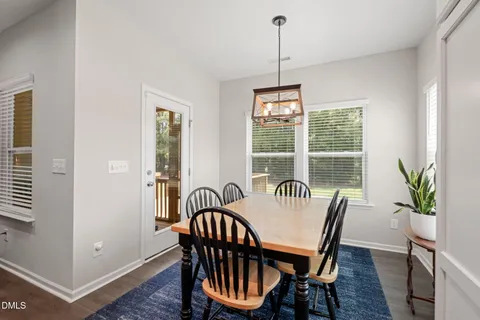 a dining room with furniture a rug and wooden floor
