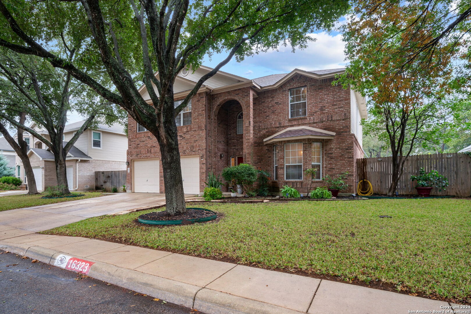 16323 Rangerider San Antonio, TX 78247 - Photo 2 of 36 a front view of a house with a garden
