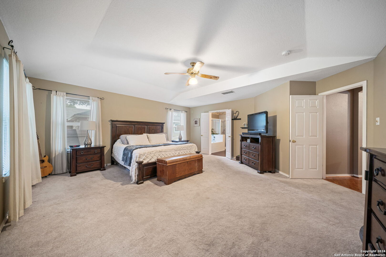 16323 Rangerider San Antonio, TX 78247 - Photo 21 of 36 a spacious bedroom with a bed and a chandelier