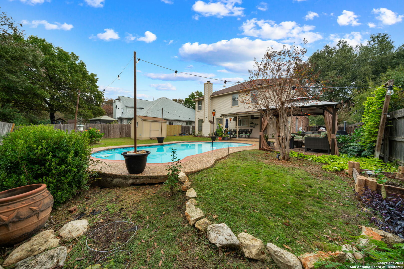 16323 Rangerider San Antonio, TX 78247 - Photo 34 of 36 a view of a patio with table and chairs potted plants and large tree