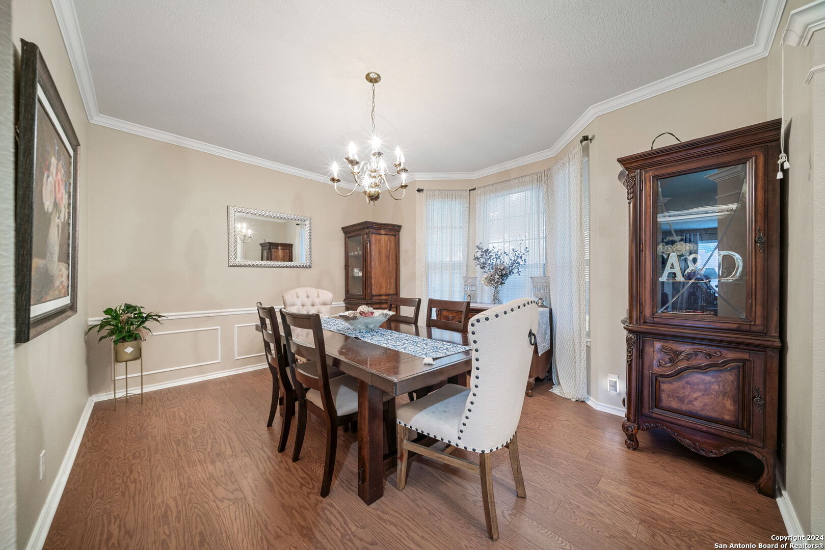 16323 Rangerider San Antonio, TX 78247 - Photo 7 of 36 a view of a dining room with furniture wooden floor and chandelier