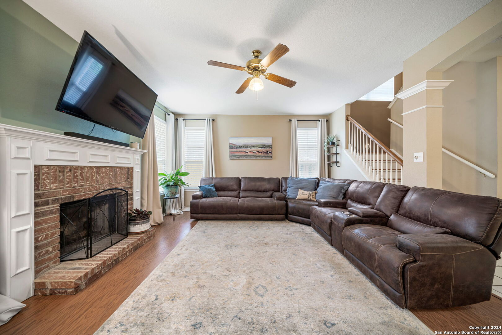 16323 Rangerider San Antonio, TX 78247 - Photo 10 of 36 a living room with furniture a fireplace and a flat screen tv
