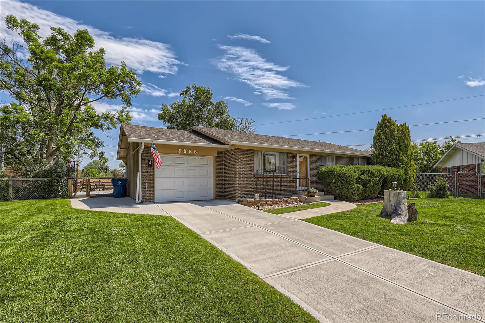 5366 Field Circle Arvada, CO 80002 - Photo 1 of 28 a front view of a house with a yard and garage