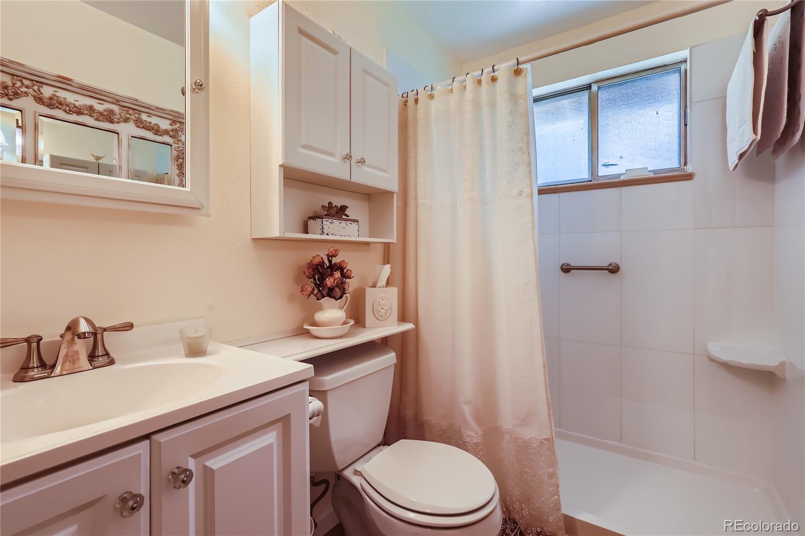 5366 Field Circle Arvada, CO 80002 - Photo 15 of 28 a bathroom with a sink a toilet and shower