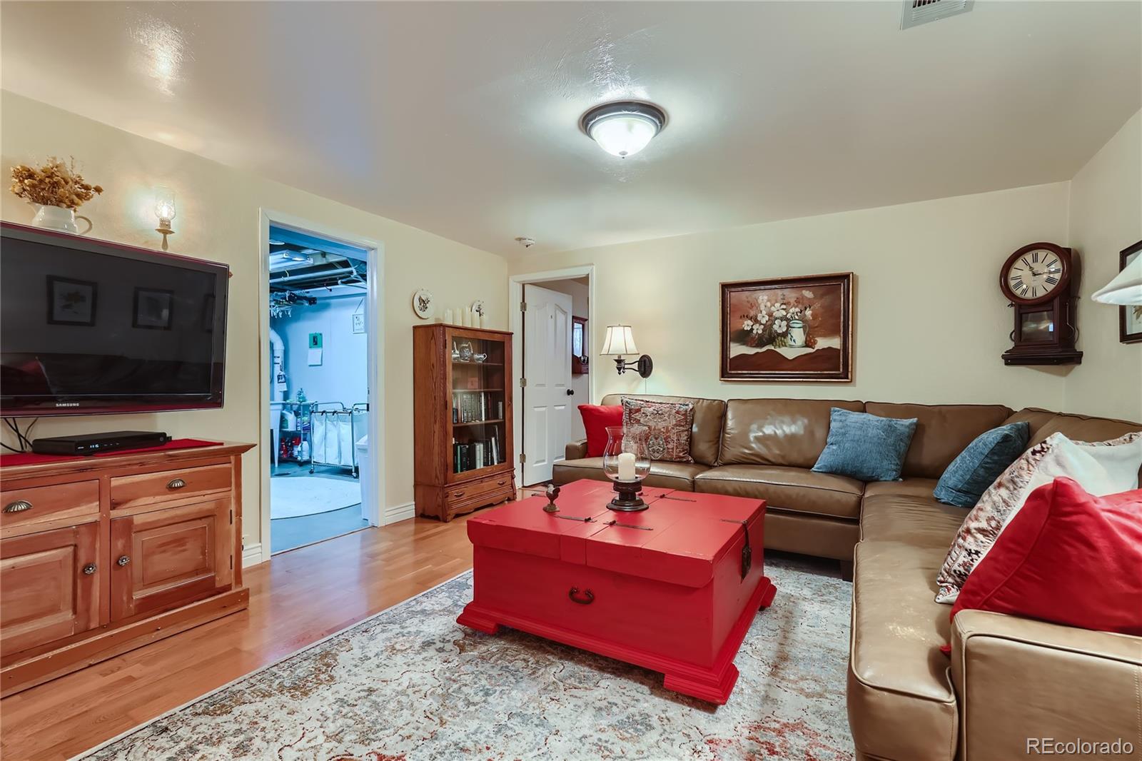 5366 Field Circle Arvada, CO 80002 - Photo 22 of 28 a living room with furniture and a flat screen tv