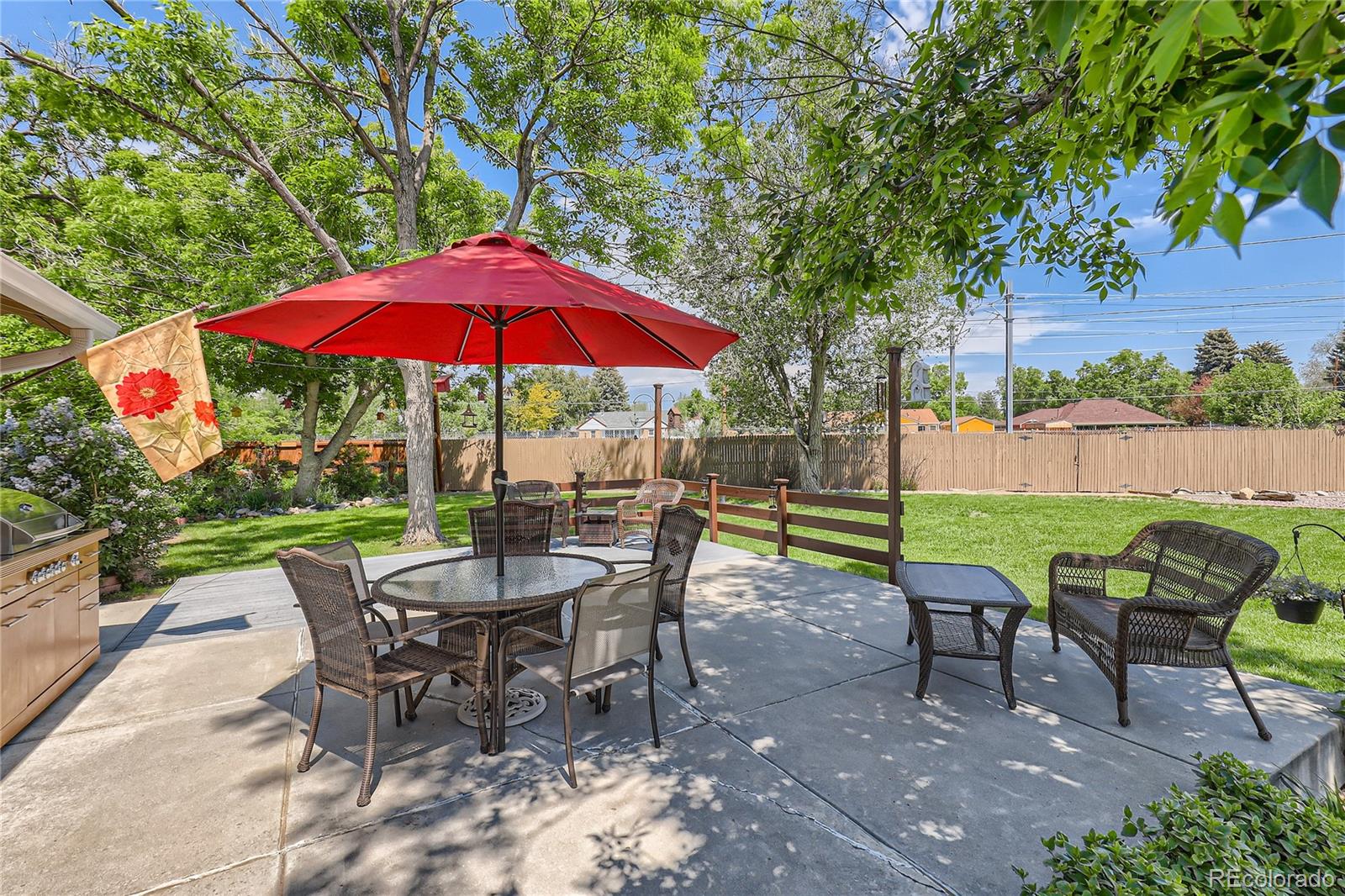 5366 Field Circle Arvada, CO 80002 - Photo 25 of 28 a view of a table and chairs under an umbrella in backyard