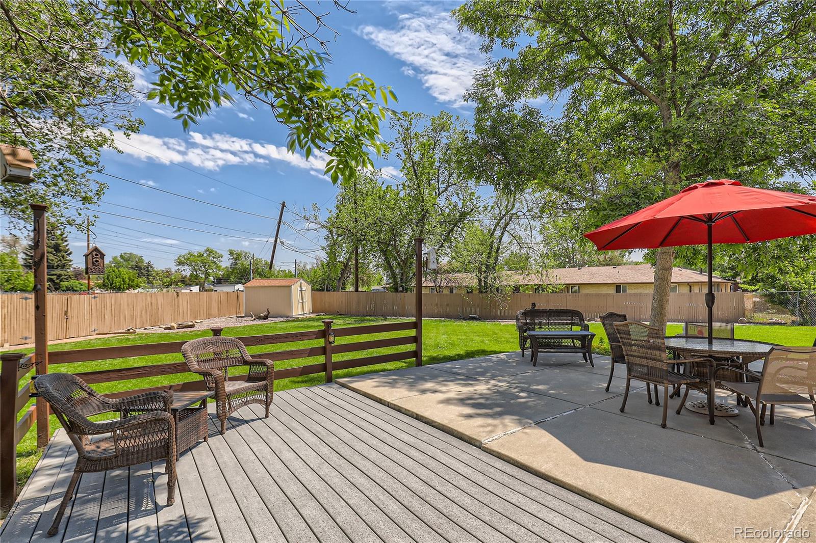 5366 Field Circle Arvada, CO 80002 - Photo 26 of 28 an outdoor sitting area with furniture and wooden deck