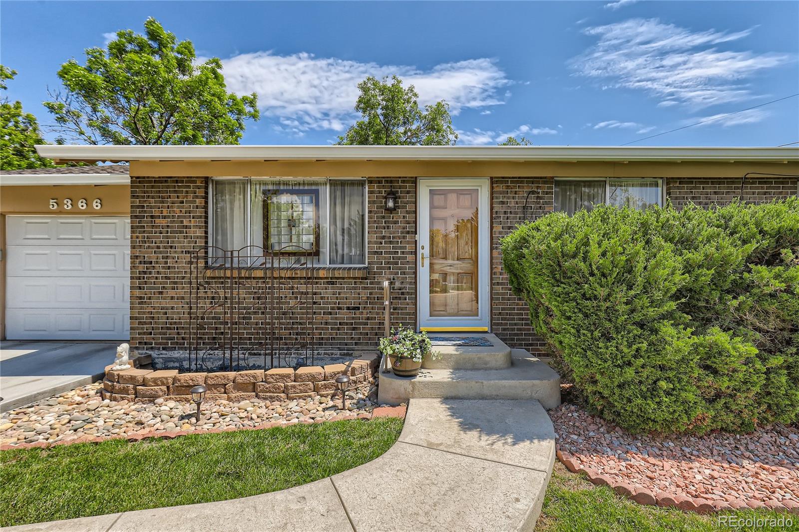 5366 Field Circle Arvada, CO 80002 - Photo 3 of 28 a front view of a house with garden
