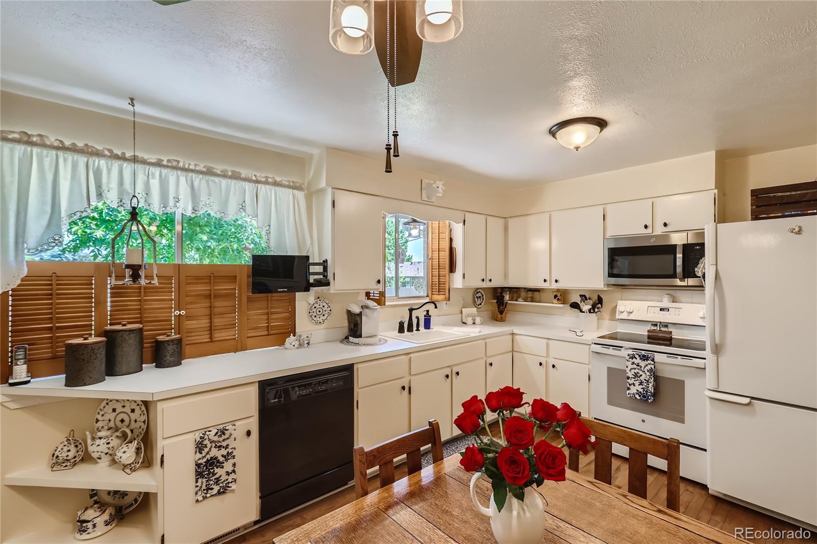 5366 Field Circle Arvada, CO 80002 - Photo 10 of 28 a kitchen with stainless steel appliances kitchen island granite countertop a sink stove and refrigerator