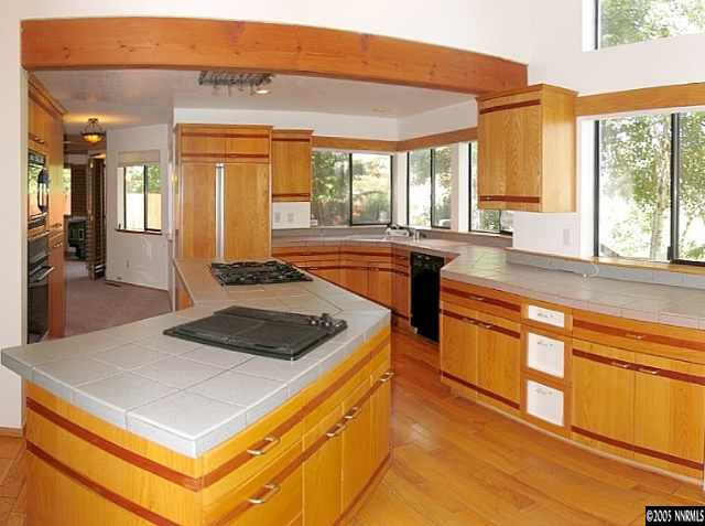 4075 Riverhaven Drive Reno, NV 89519 - Photo 4 of 9 a kitchen with stainless steel appliances granite countertop a stove a sink and a refrigerator