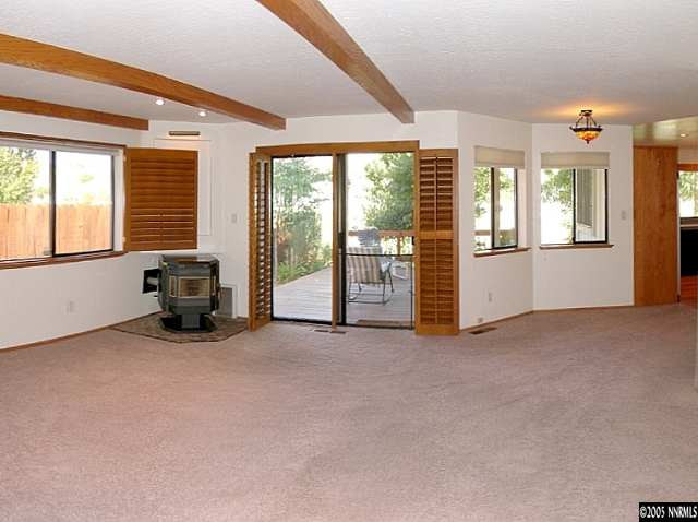 4075 Riverhaven Drive Reno, NV 89519 - Photo 5 of 9 a view of an empty room with a fireplace and a large window