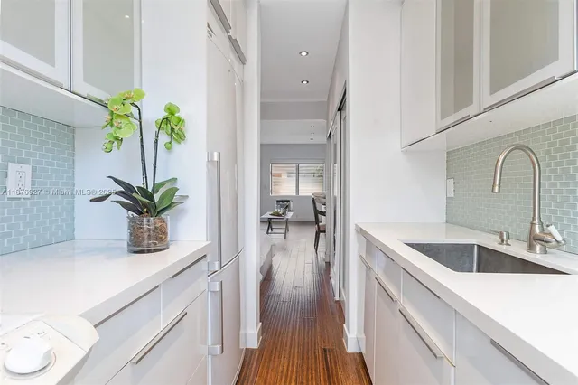 a kitchen with sink refrigerator and stove