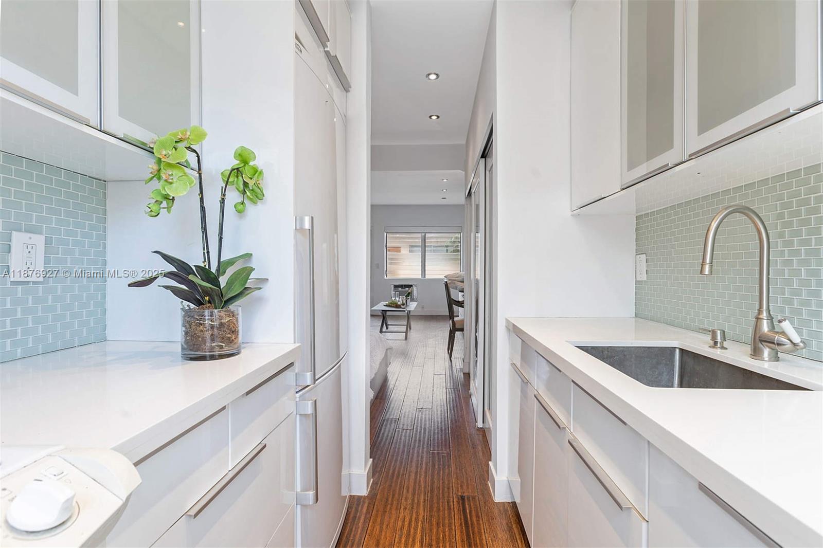 1050 Pennsylvania Avenue, Unit 29 Miami Beach, FL 33139 - Photo 11 of 23 a kitchen with sink refrigerator and stove
