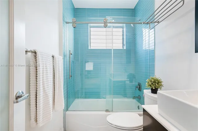 a bathroom with a bathtub toilet and shower