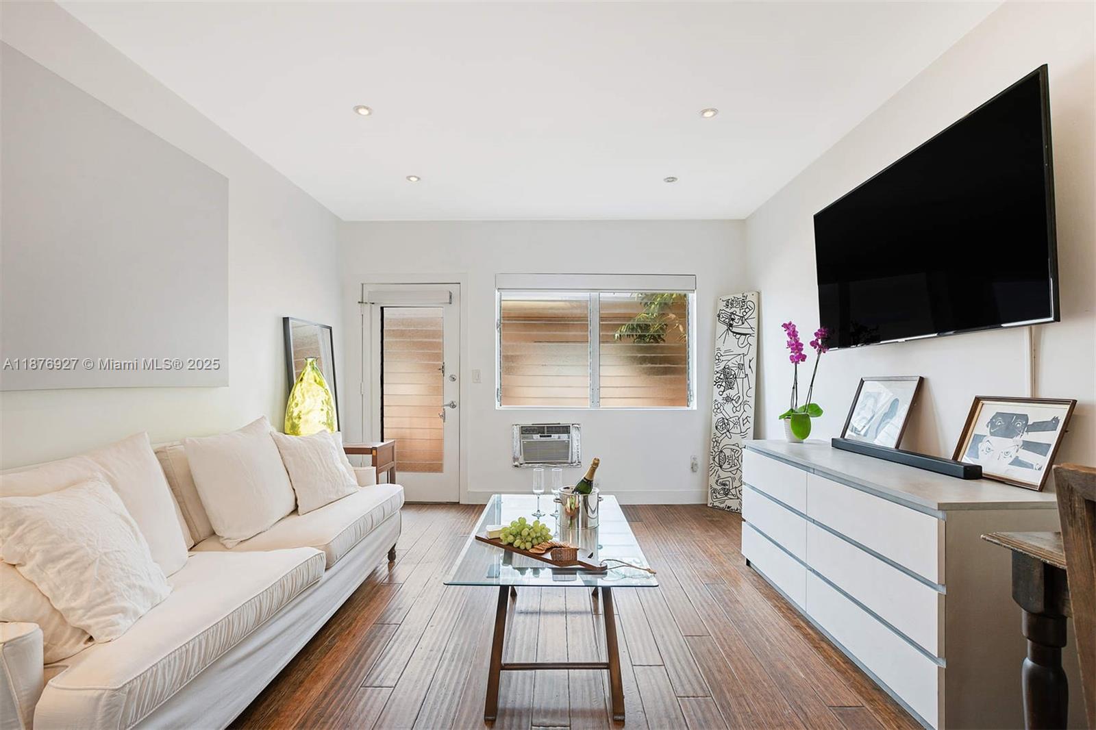 1050 Pennsylvania Avenue, Unit 29 Miami Beach, FL 33139 - Photo 3 of 23 a living room with furniture and a flat screen tv