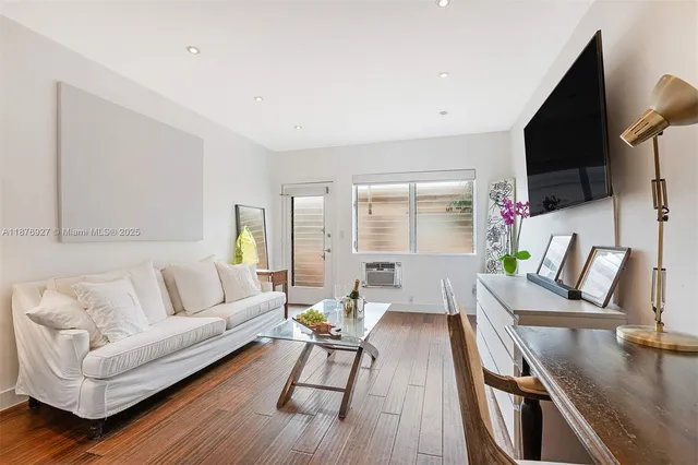 a living room with fireplace furniture and a flat screen tv
