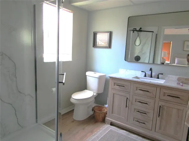 a bathroom with a toilet sink double vanity and mirror