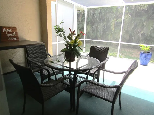 a view of a dining room with furniture and a potted plant