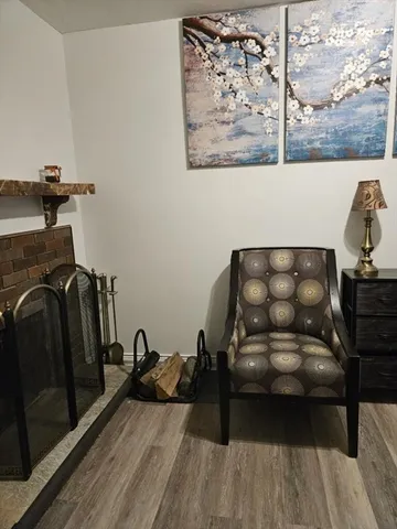 a view of a workspace with furniture and wooden floor