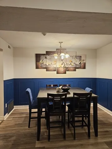 a view of a dining room with furniture and wooden floor