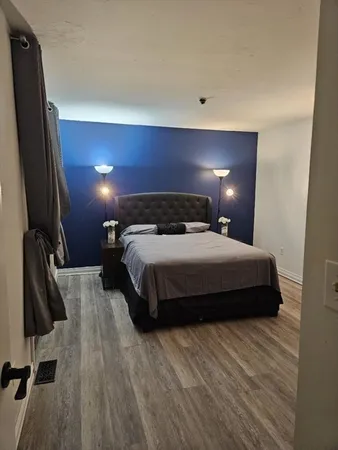 a bedroom with a bed and a flat screen tv