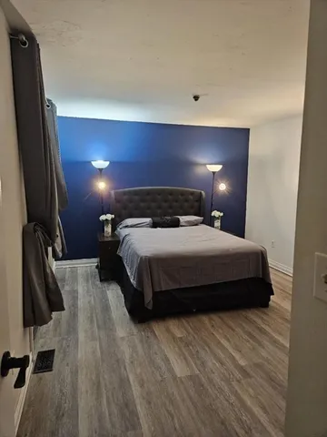 a bedroom with a bed and a flat screen tv